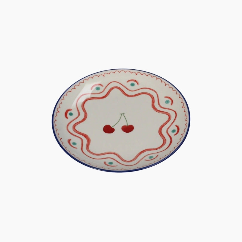 Decorative plate with cherry design on a white background