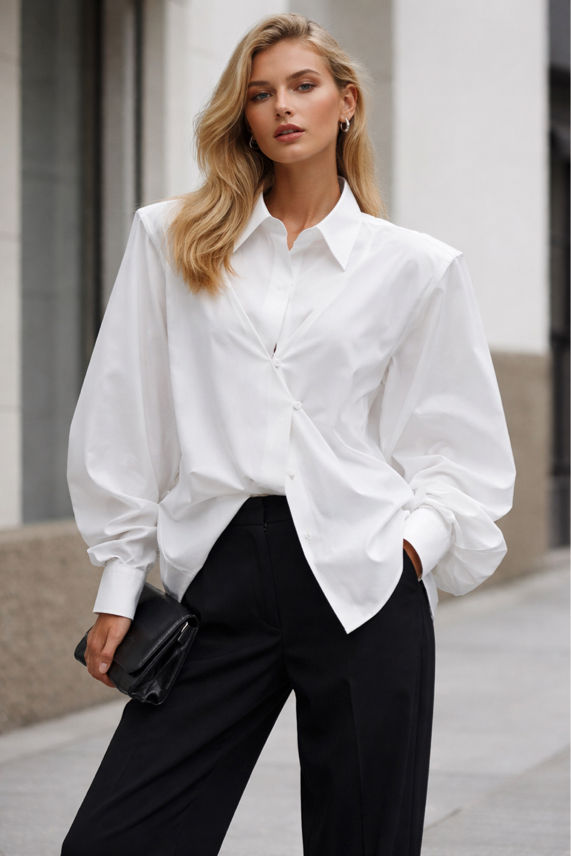Woman wearing a white shirt and black pants on a city street.