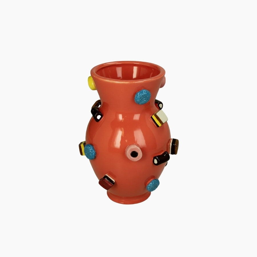 Decorative vase with colorful embellishments on a white background