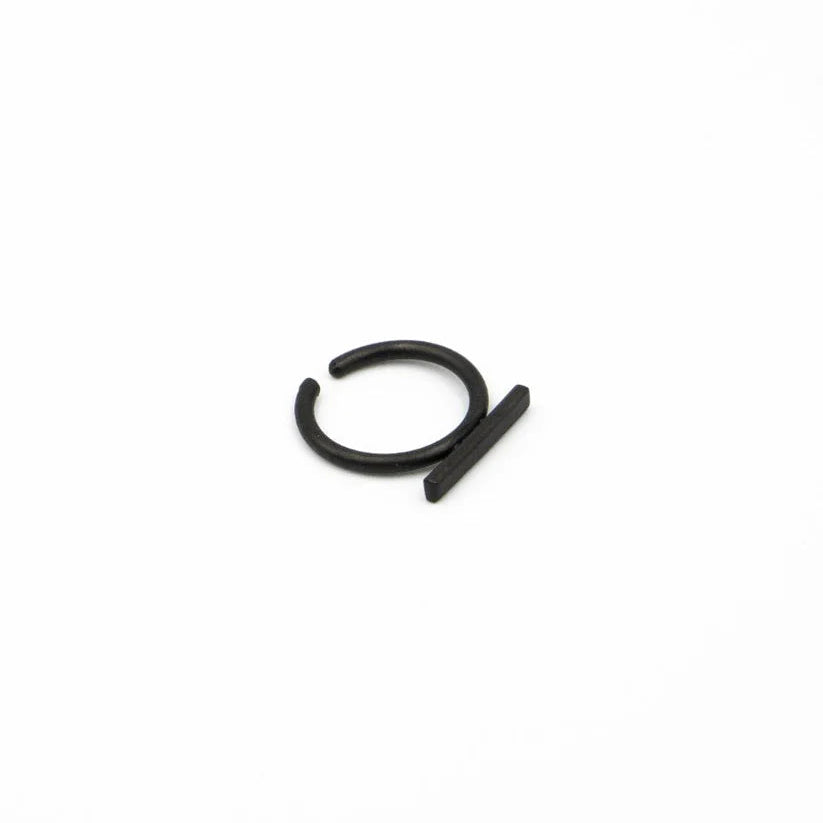 Black metal clip on earring on a white background