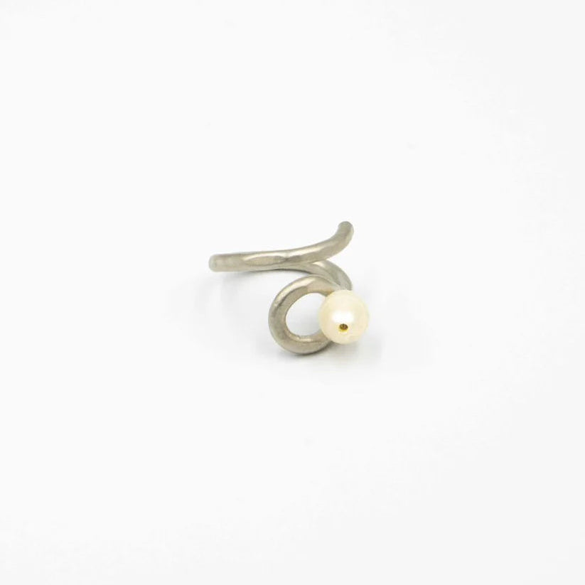 Silver earring with a pearl on a white background