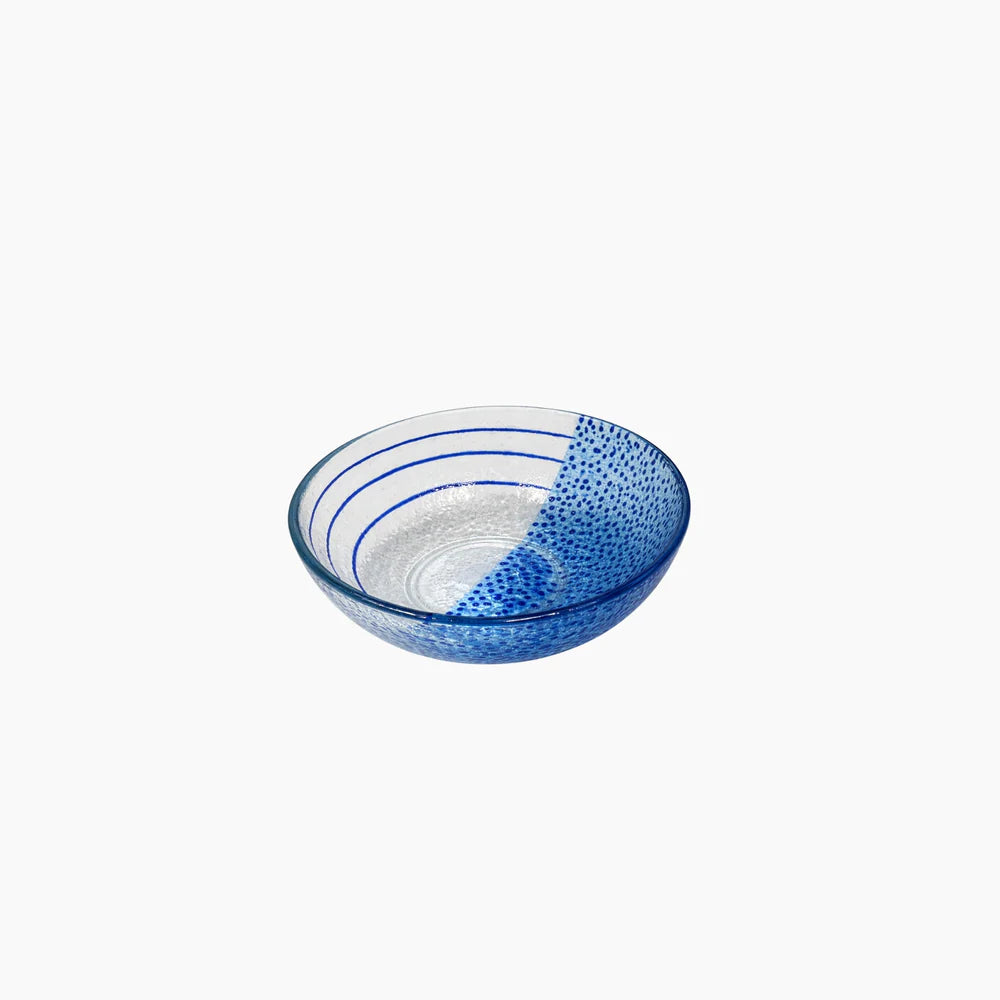 Blue glass bowl with textured design on a white background
