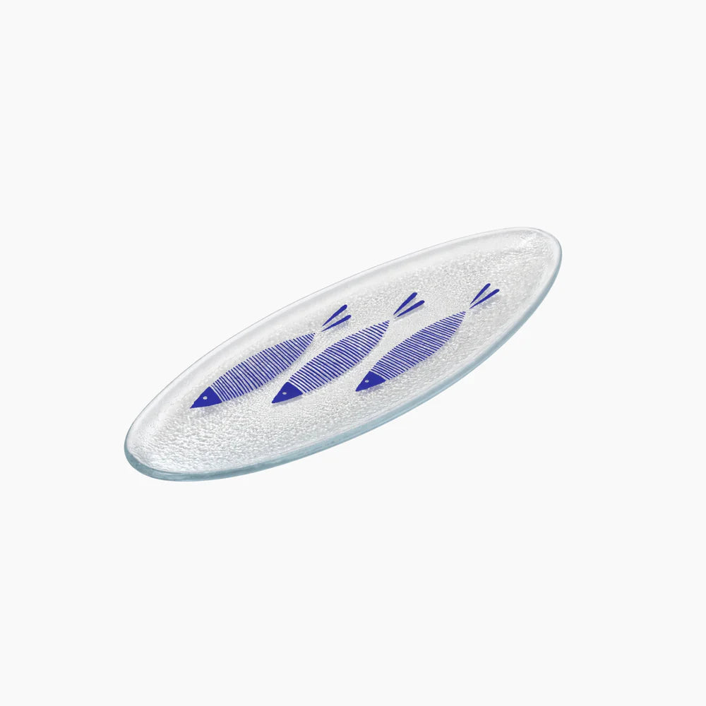 Glass plate with blue fish designs on a white background