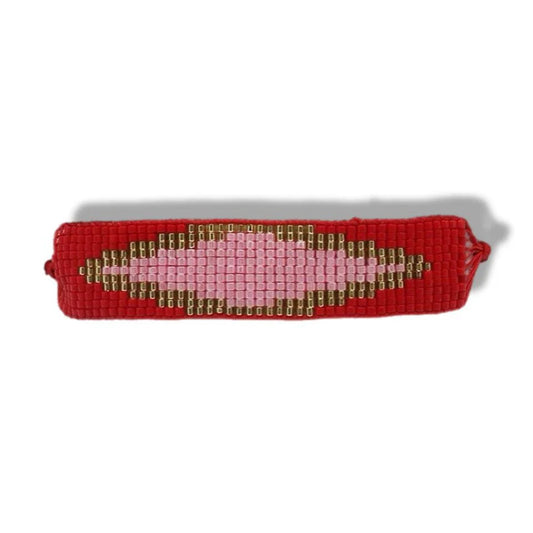 Red woven bracelet with a pink heart design on a white background