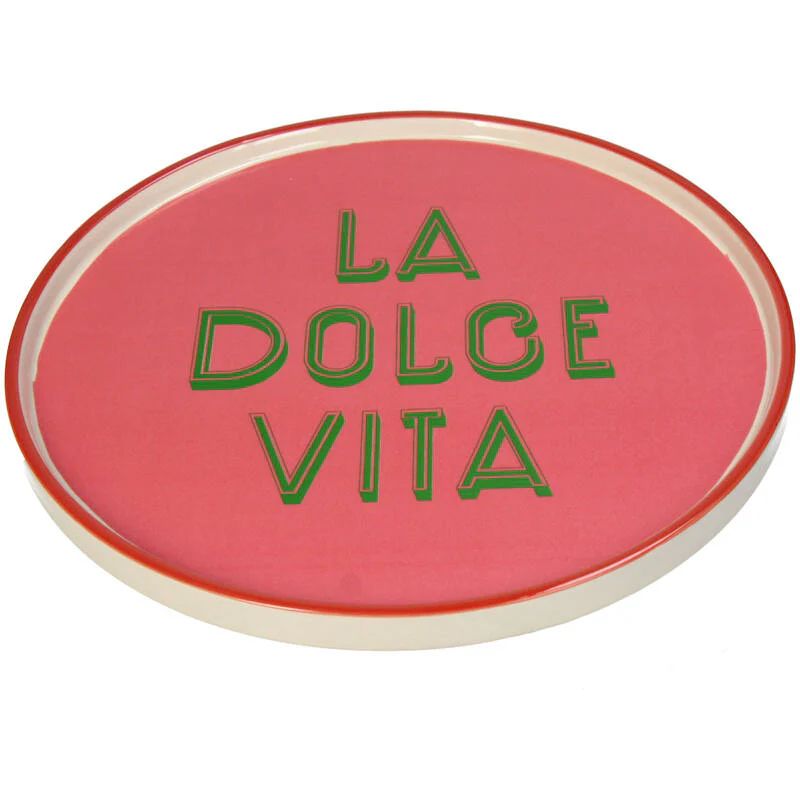 Pink circular object with 'La Dolce Vita' text in green on a white background