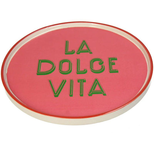 Pink circular object with 'La Dolce Vita' text in green on a white background