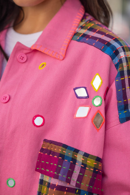 Close-up of a pink jacket with colorful patchwork details