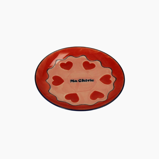 Ceramic plate with red hearts and 'Ma Chérie' text on a white background