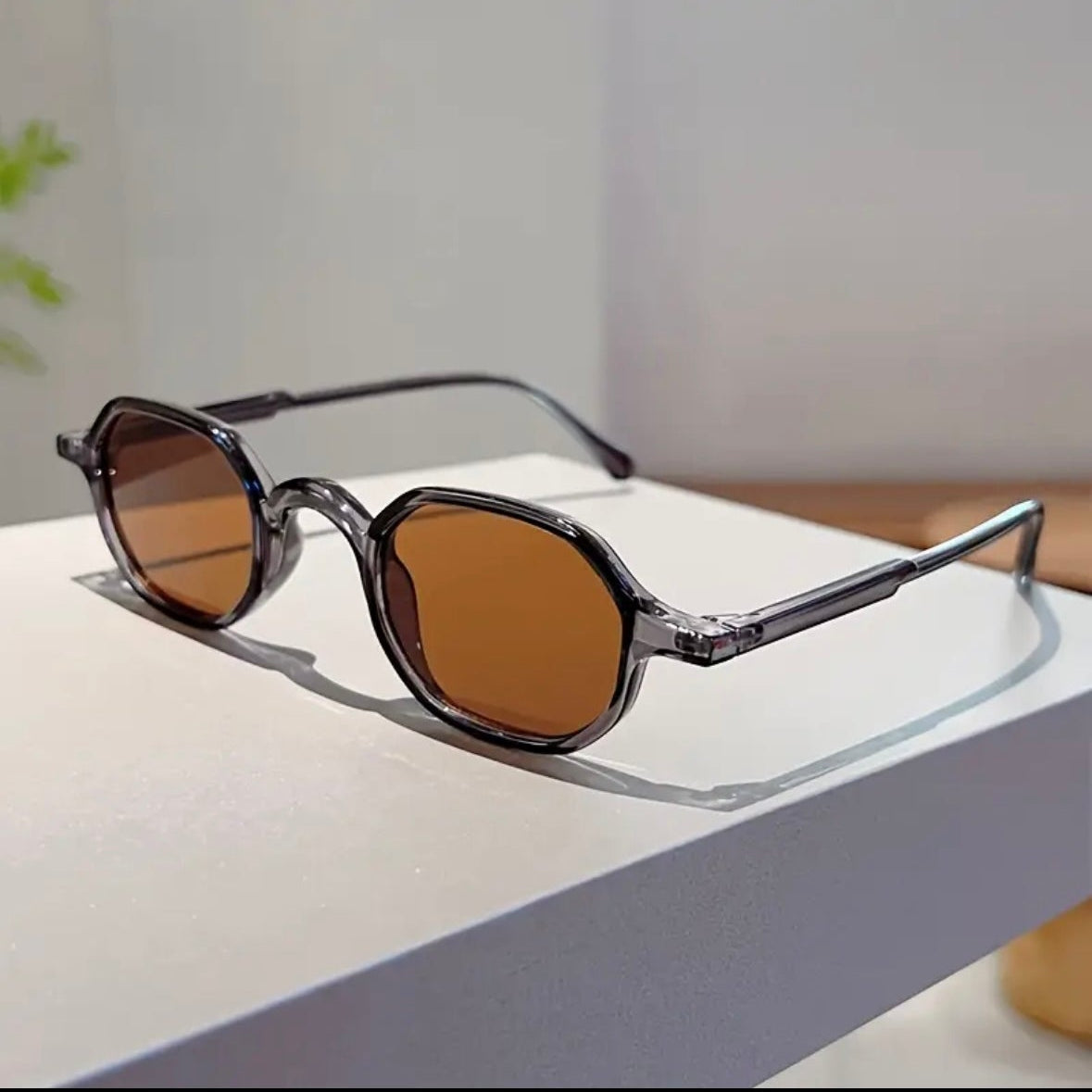 Sunglasses with brown lenses on a white surface