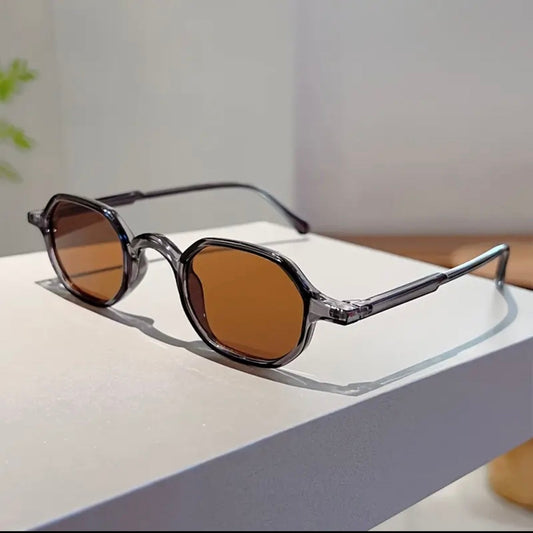Sunglasses with brown lenses on a white surface