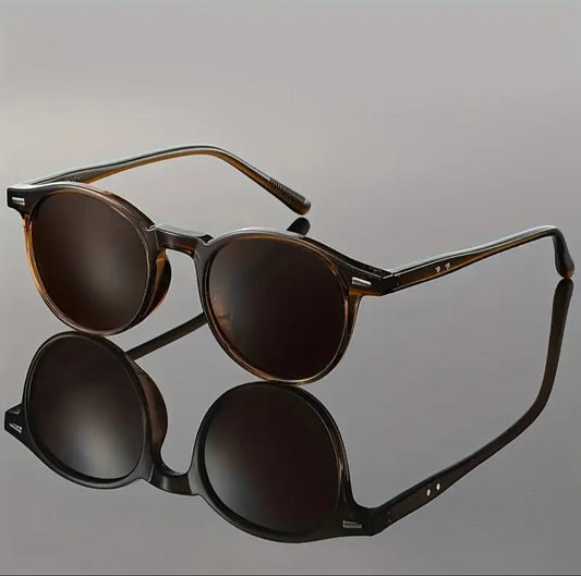 Pair of sunglasses with reflective lenses on a gray background