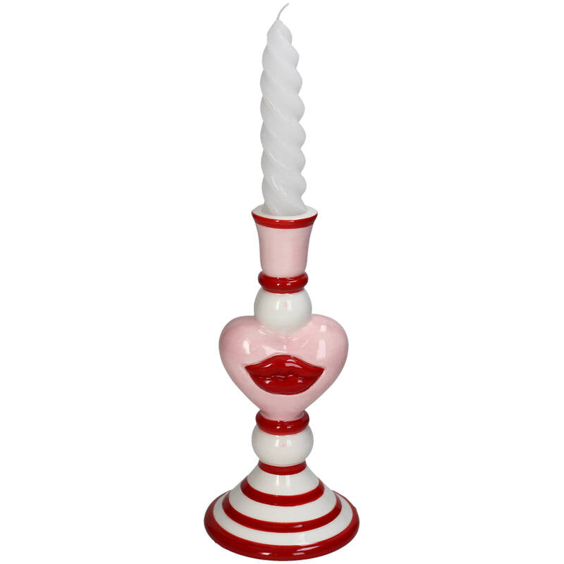 Decorative candle holder with a white candle on a white background