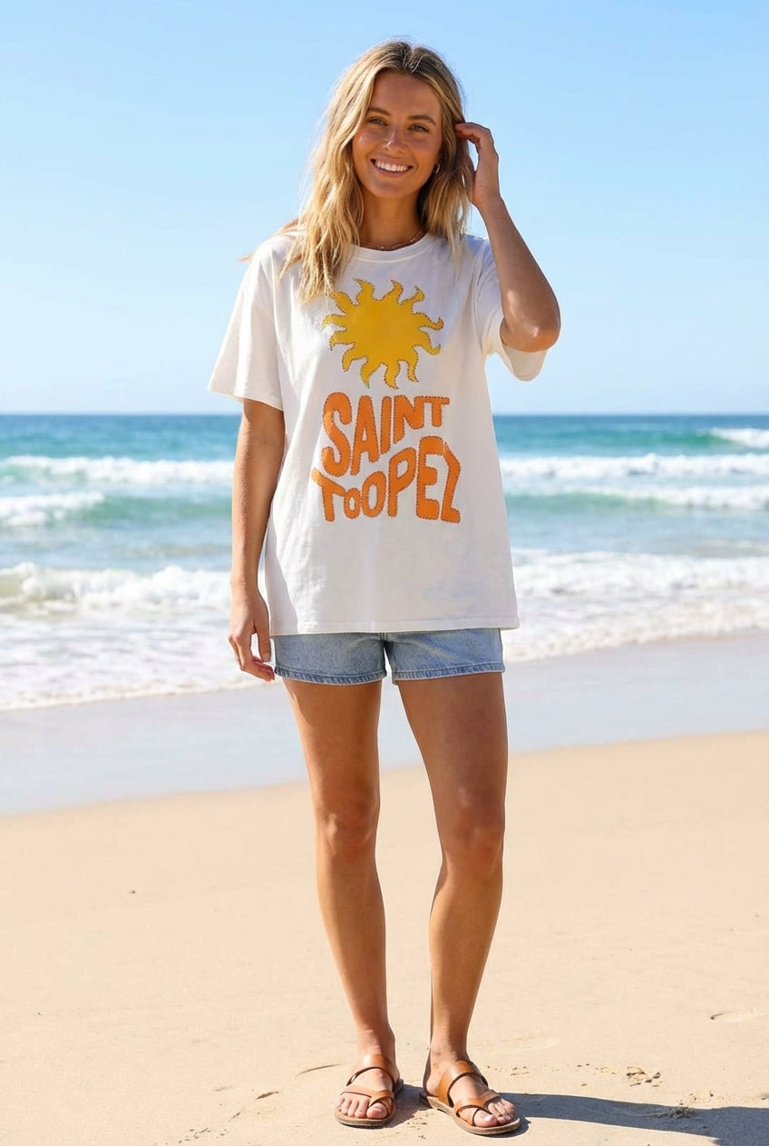 Woman wearing a 'Saint Tropez' t-shirt on a beach