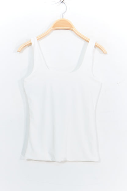 White tank top on a wooden hanger against a white background
