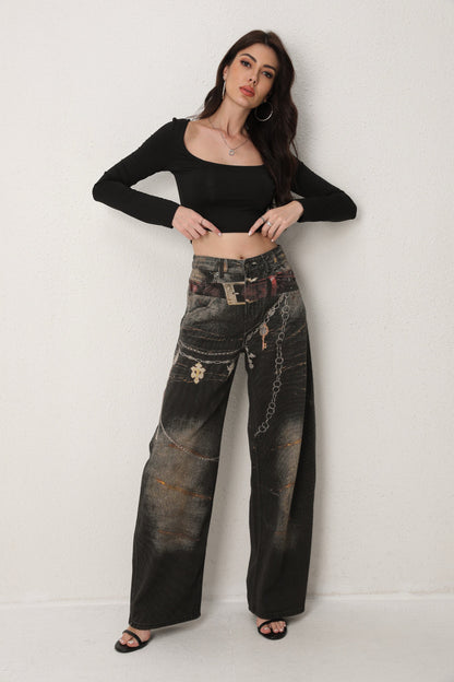 Woman wearing a black crop top and distressed black jeans against a white background