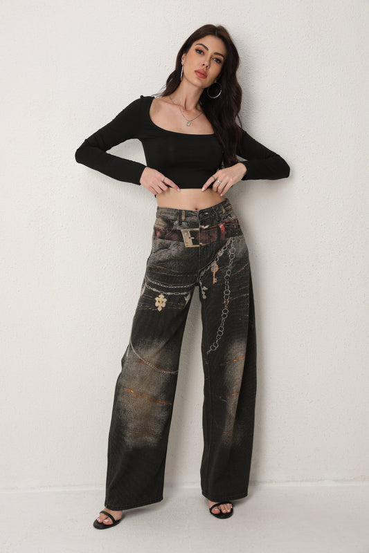 Woman wearing a black crop top and distressed black jeans against a white background