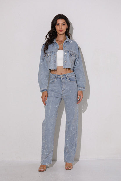 Woman wearing a light blue denim outfit with a white top against a plain background
