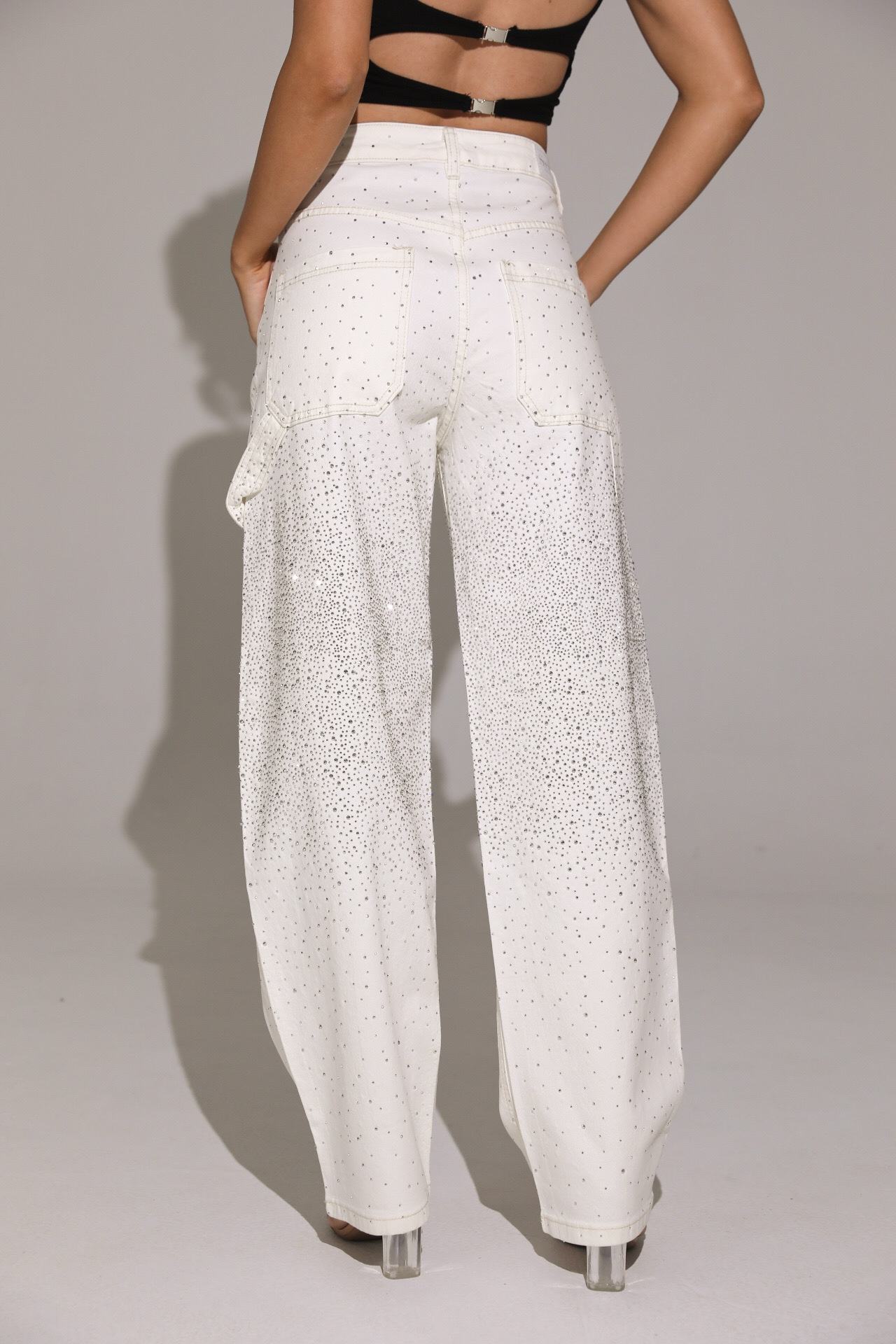 White wide-leg pants worn by a person on a plain background