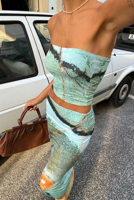 Person wearing a green patterned outfit with a car in the background