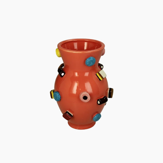 Decorative vase with colorful embellishments on a white background