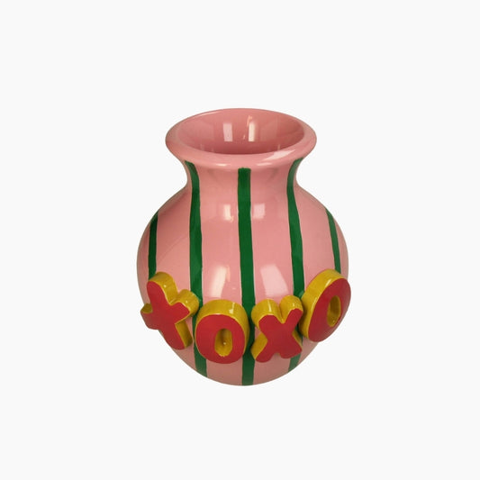 Pink vase with green stripes and colorful letters on a white background