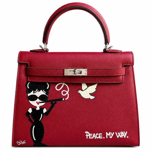 Red handbag with artistic design and 'Peace. My Way' text on a white background