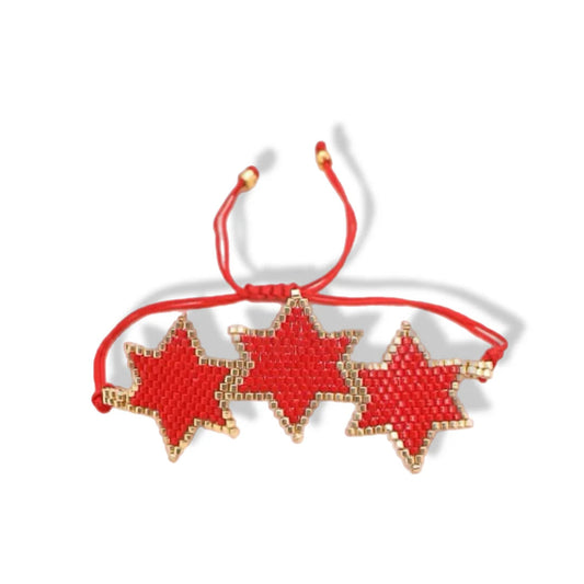 Red star-shaped bracelet with gold accents on a white background