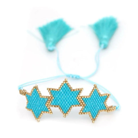 Turquoise star-shaped beaded hair tie with tassels on a white background