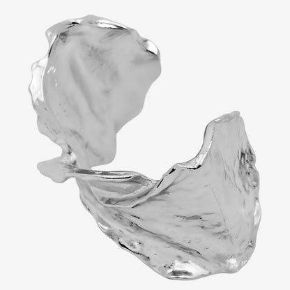 silver leaf-shaped bracelet on a black background