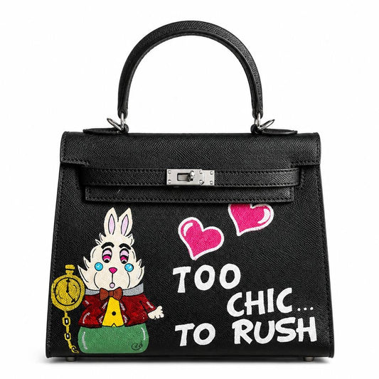 Black handbag with cartoon character and text 'Too Chic... To Rush' on a white background