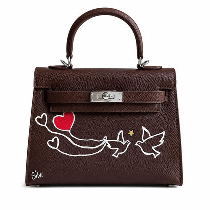 Brown handbag with artistic designs on a white background