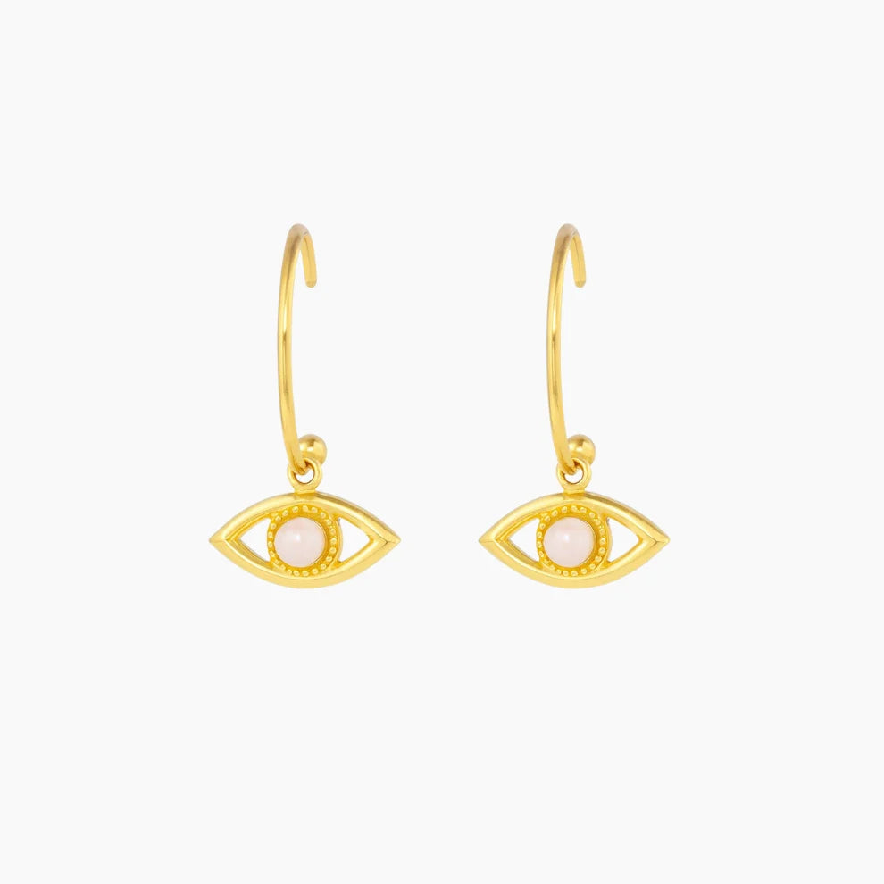 Gold eye-shaped earrings on a white background