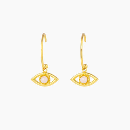 Gold eye-shaped earrings on a white background