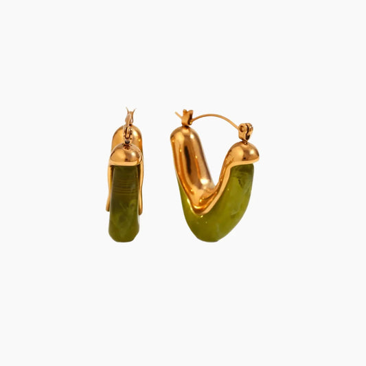 Gold hoop earrings with green stones on a white background