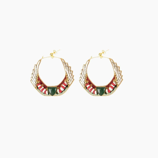 Pair of gold hoop earrings with red and green accents on a white background