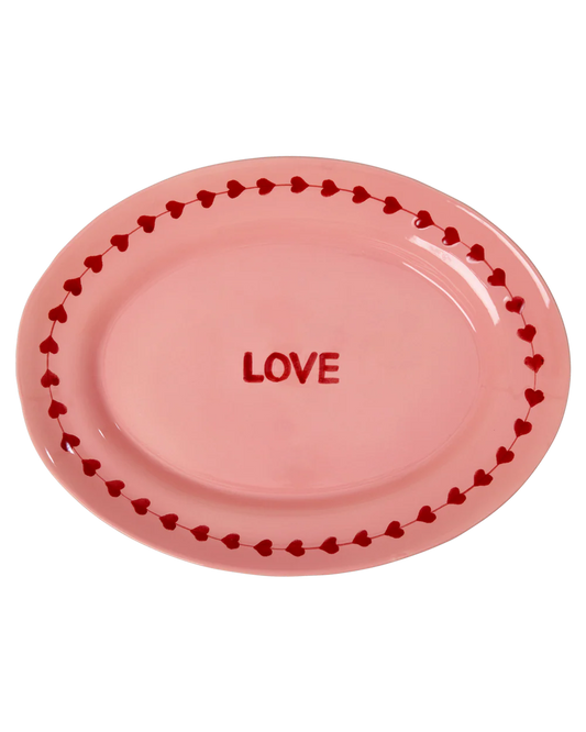 Pink plate with 'LOVE' text and heart border on a white background