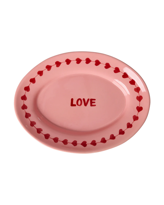 Pink oval plate with 'LOVE' text and heart border on a white background