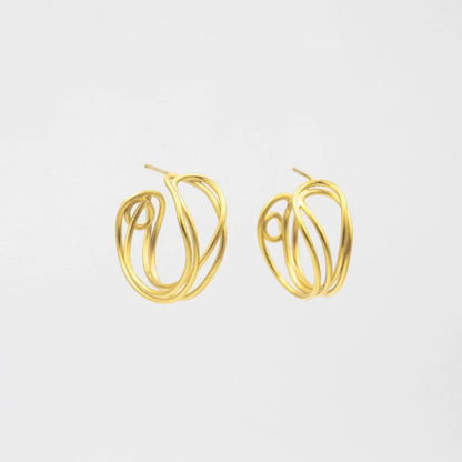 Gold hoop earrings on a light gray background