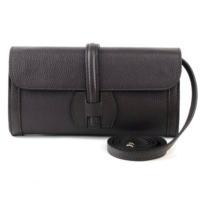 Black leather handbag with a strap on a white background