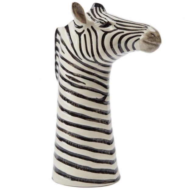 Zebra head sculpture with black and white stripes on a white background