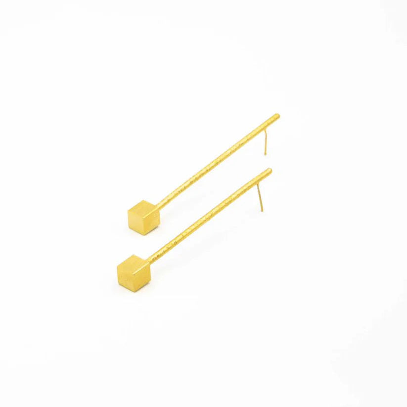 Yellow geometric earrings on a white background