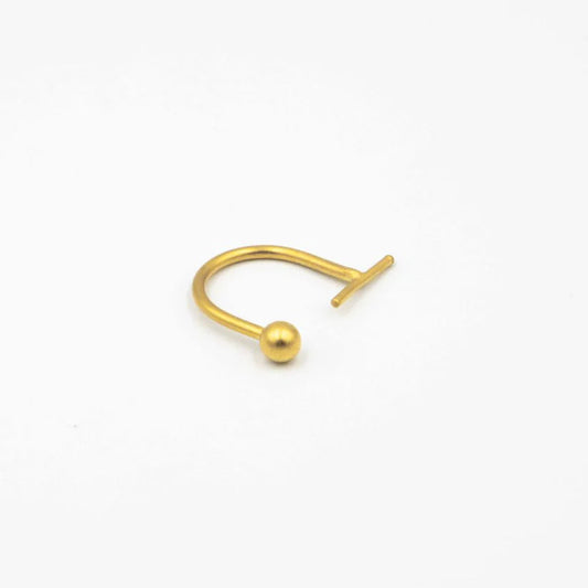 Gold nose ring on a white background