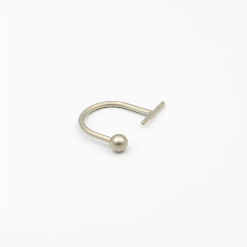 Silver nose ring with a small ball on a white background