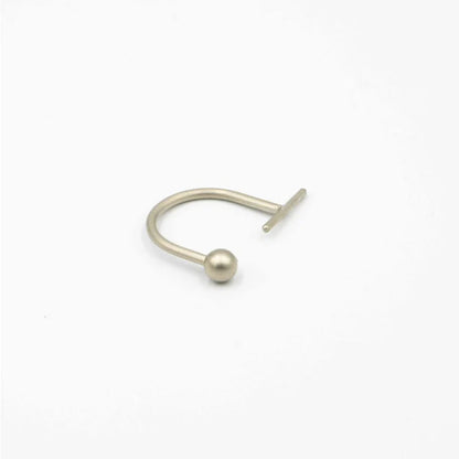 Silver nose ring with a small ball on a white background