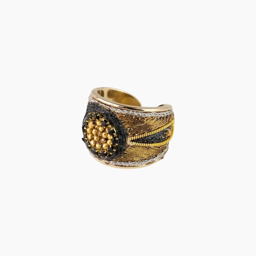 Gold and black ring on a white background