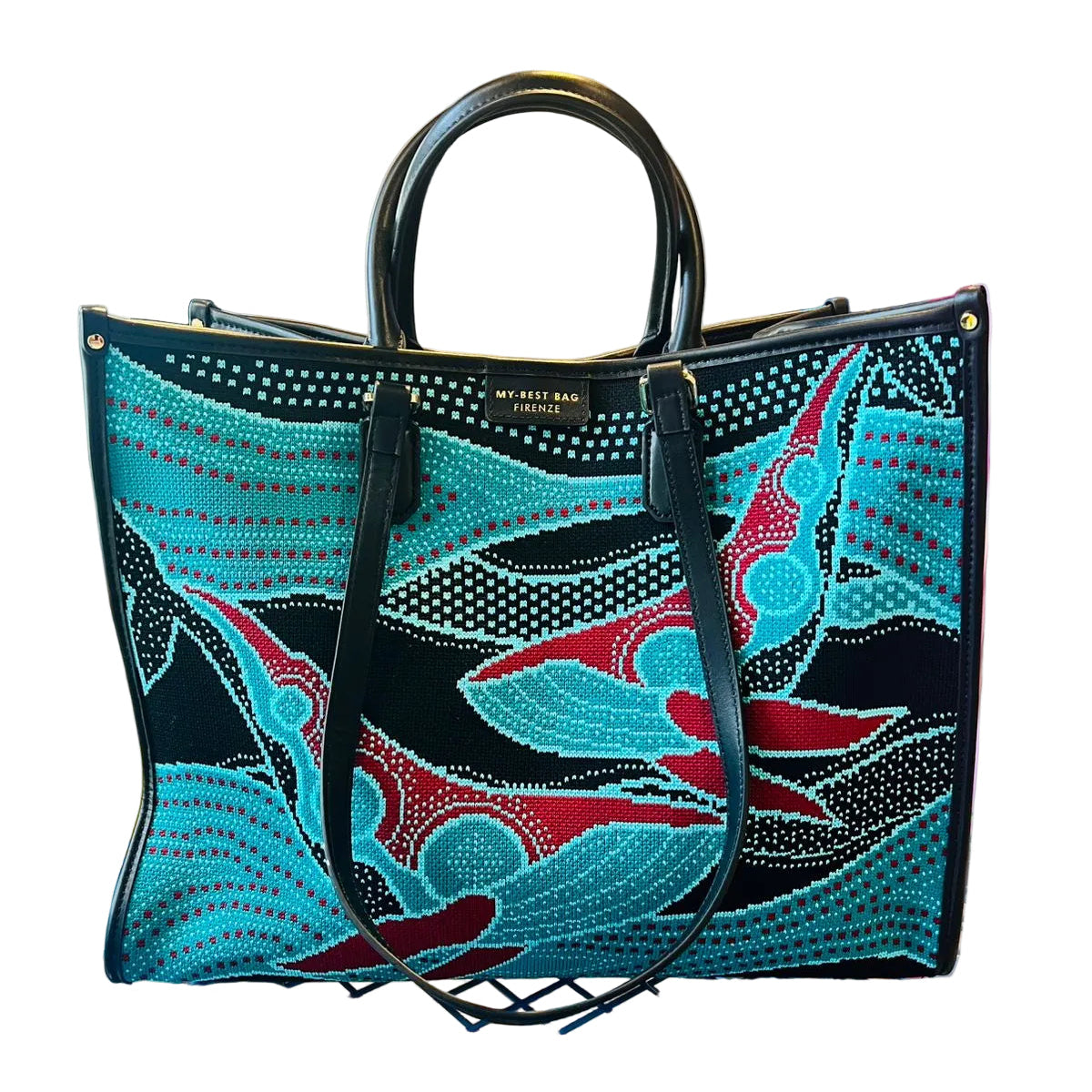 Colorful handbag with abstract design on a metal surface