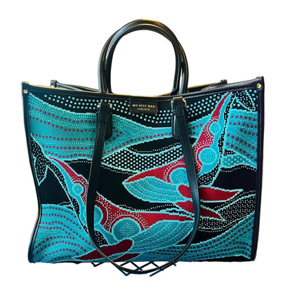 Colorful handbag with abstract design on a metal surface