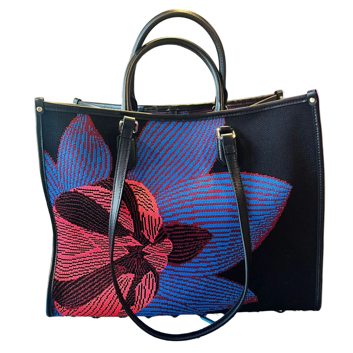 Black handbag with red and blue floral embroidery on a glass surface.
