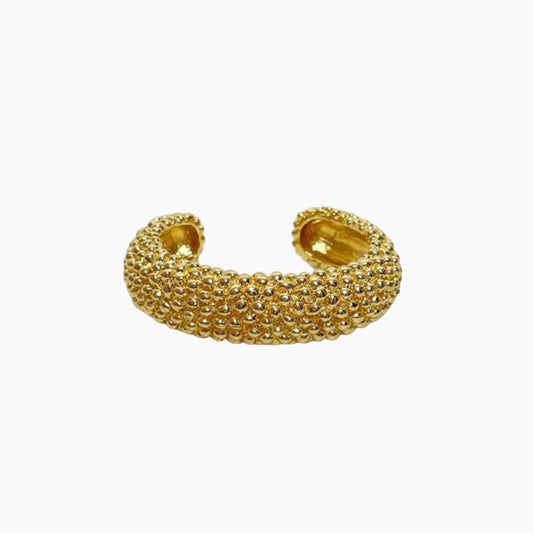 Gold beaded cuff bracelet on a white background