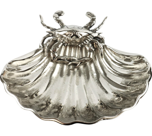 Silver shell-shaped dish with crab design on a white background